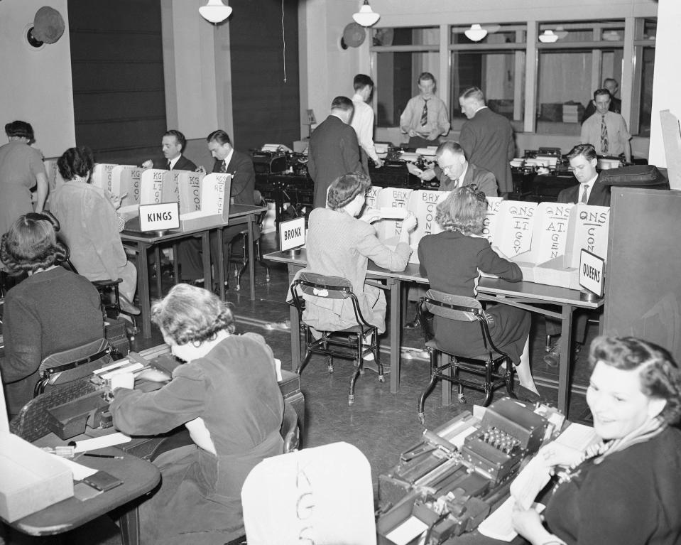 Tabulators record the Associated Press election returns in the offices of IBM in New York City on Election Day, Nov. 3, 1942. The returns are received on the teletype machines (background) and recorded with the aid of the numeric punching and printing machines in the foreground. (AP Photo/Matty Zimmerman)