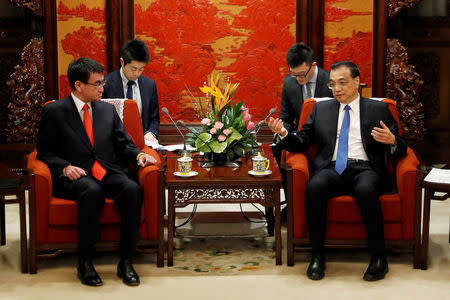 Japanese Foreign Minister Taro Kono, left, meets with Chinese Premier Li Keqiang at the Zhongnanhai Leadership Compound in Beijing, Sunday, Jan. 28, 2018. REUTERS/Andy Wong/Pool