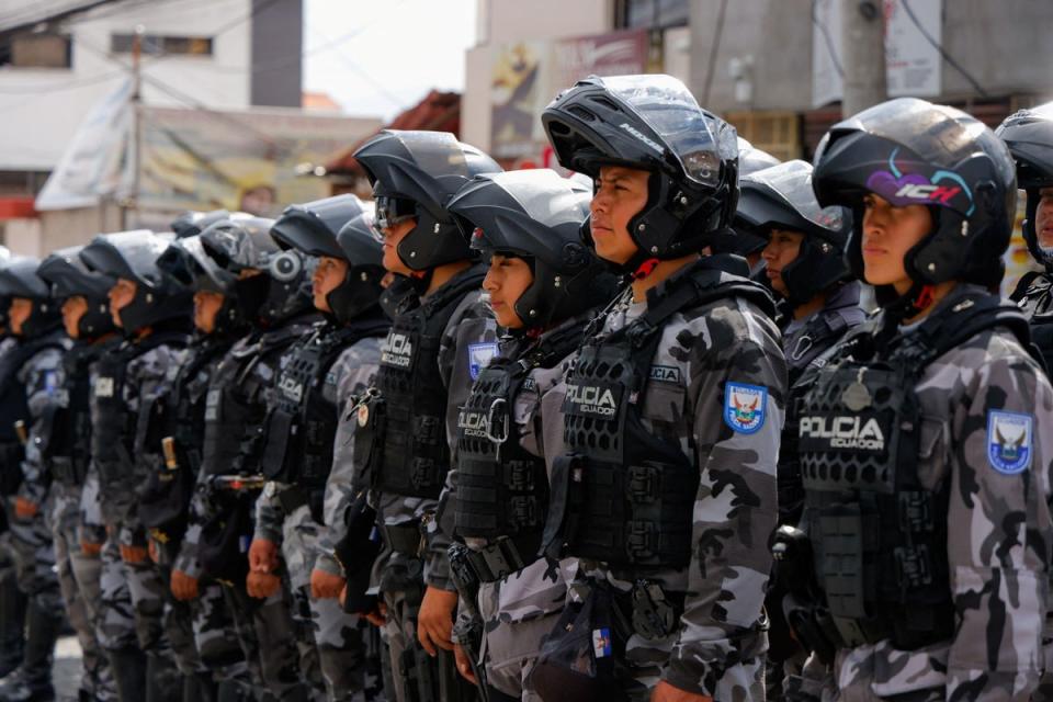 Police officers stand in formation outside El Inca prison (REUTERS)