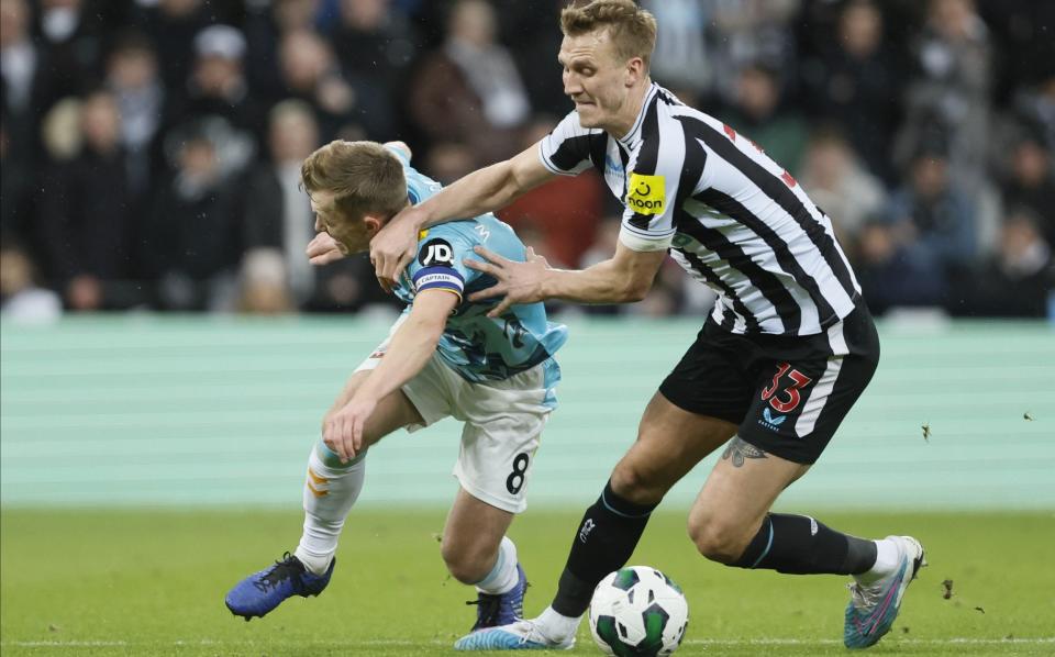 James Ward-Prowse of Southampton and Dan Burn of Newcastle United challenge during the Carabao Cup - Richard Sellers/Getty Images