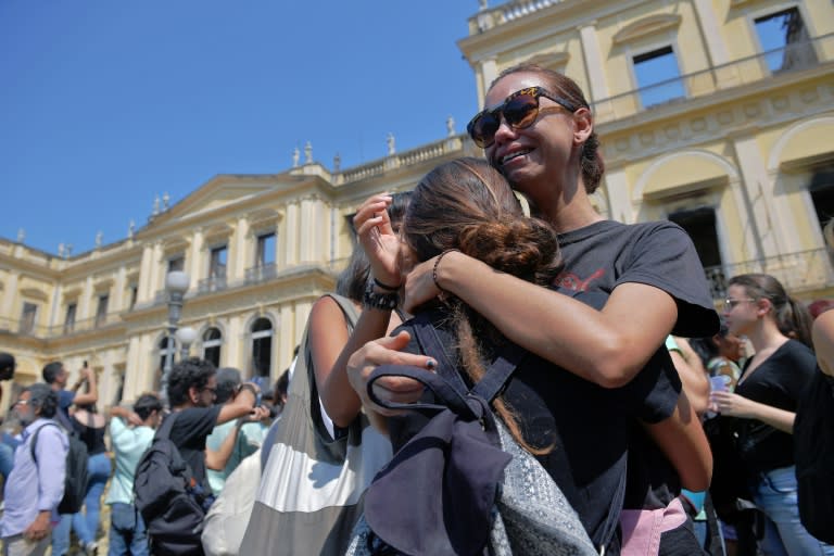 Students and researchers gathered to demonstrate outside the museum's still-smoldering remains