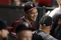 Arizona Diamondbacks' Taijuan Walker gives a smile to teammates after a successful first outing against the San Diego Padres during the first inning of a baseball game Sunday, Sept. 29, 2019, in Phoenix. Taijuan Walker made his first appearance on a Major League mound since April 14, 2018. Taijuan Walker threw 15 pitches, eleven for strikes in his only inning of pitching. (AP Photo/Darryl Webb)