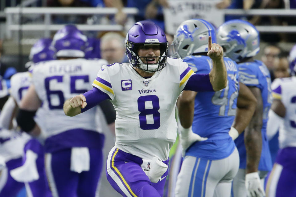 Minnesota Vikings quarterback Kirk Cousins (8) reacts after a touchdown by running back Dalvin Cook during the second half of an NFL football game against the Detroit Lions, Sunday, Oct. 20, 2019, in Detroit. (AP Photo/Duane Burleson)