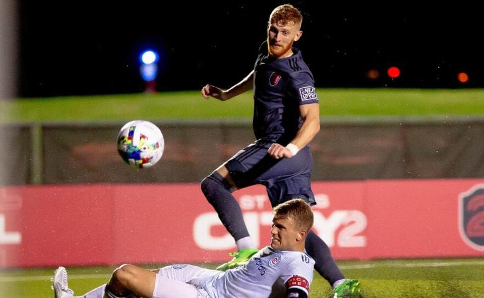 Chicago Fire 2 defender Carlo Ritaccio (50) slides after losing control of the ball from St. Louis City 2 forward Josh Dolling (9) on Aug. 6 during a matchup at Ralph Korte Stadium in Edwardsville. Dolling scored a goal, helping lead City 2 to a 2-1 win against Chicago.