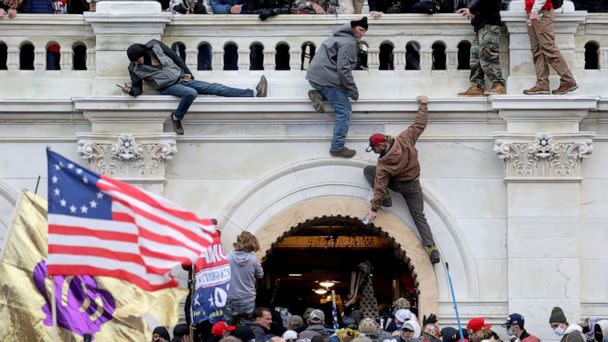 PHOTO: A mob of supporters of President Donald Trump fight with members of law enforcement at a door they broke open as they storm the Capitol, Jan. 6, 2021.  (Leah Millis/Reuters, FILE)