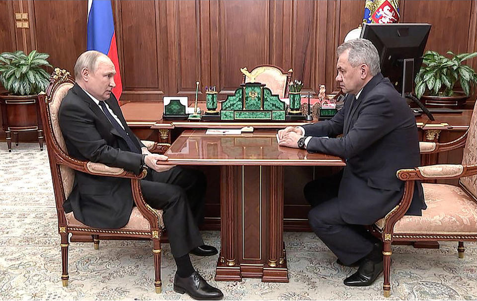 CORRECTION / This handout photograph taken and released by the Russian Presidential Press Office, on April 21, 2022 shows Russian President Vladimir Putin (L) speaking with Russian Defence Minister Sergei Shoigu during their meeting at the Kremlin in Moscow.  - RESTRICTED TO EDITORIAL USE - MANDATORY CREDIT 