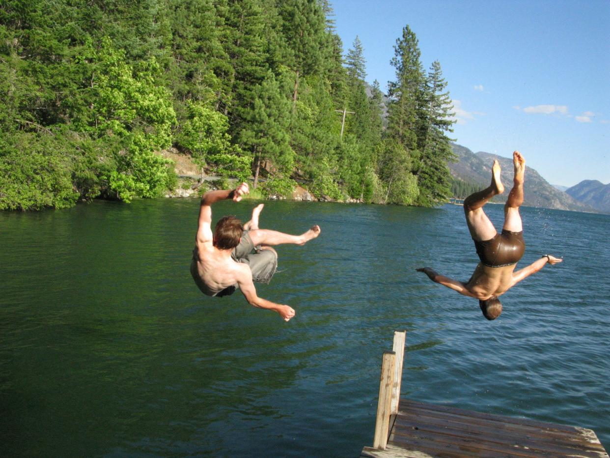 People jump off a dock at North Cascades National Park.