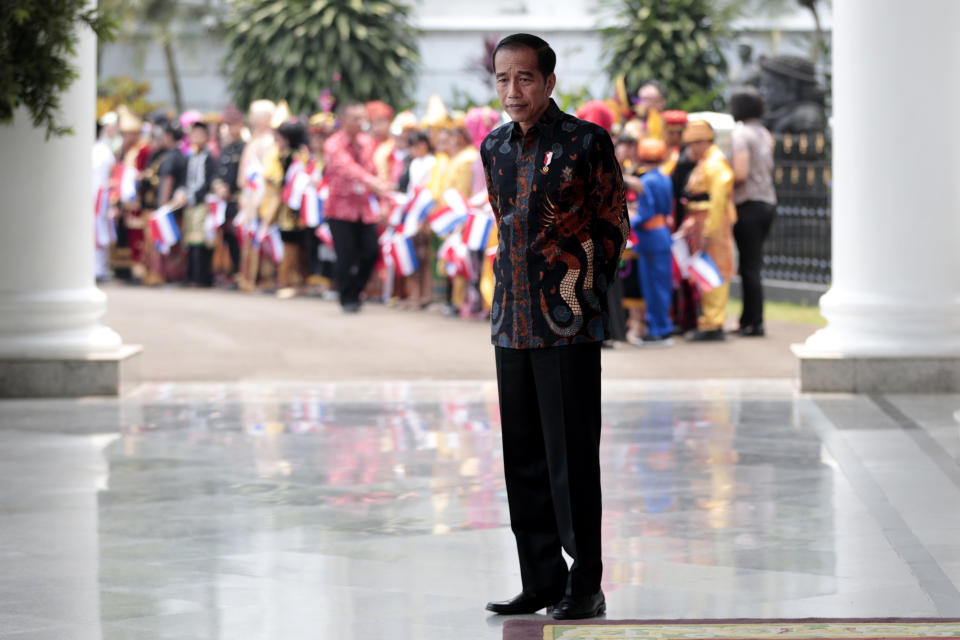 In this Oct. 7, 2019, photo, Indonesian President Joko Widodo pauses during an event at the presidential palace in Bogor, Indonesia. Known for his down-to-earth style with a reputation for clean governance, Widodo's signature policy has been improving Indonesia's inadequate infrastructure and reducing poverty, which afflicts close to a tenth of Indonesia's nearly 270 million people. But raising money would be harder at a time of global economic slowdown, major trade conflicts and falling exports. (AP Photo/Dita Alangkara)
