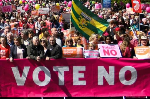 People hold up placards and banners during a 'Stand up for Life' rally