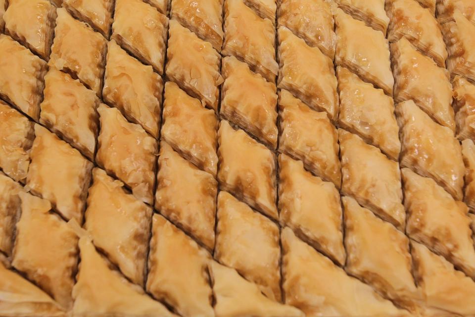 Several trays of baklawa, a traditional Lebanese pastry, are made July 18 at Our Lady of the Cedars.