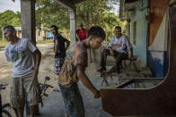 <p>Boys and men in a community in the department of Colon, BBajo Aguán region, Honduras. Another sector that has suffered a disproportionate number of attacks are peasants groups engaged in land conflicts with large agro-business enterprises â for instance, in the Bajo Aguán, where more than 100 campesino land rights activists have been killed during a drawn-out conflict with the Dinant Corporation. (Photo: Francesca Volpi) </p>