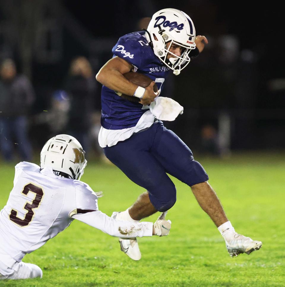 Rockland quarterback Jordan DePina was tackled by Millbury's Tyler Vaccaro during a game on Friday, Nov. 3, 2023.