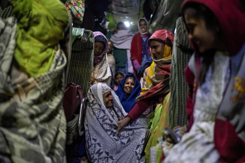 Indian pilgrims huddle inside a bus as they wait for their departure after visiting Pashupatinath temple in Kathmandu, Nepal, Friday, Jan. 12, 2024. The centuries-old temple is one of the most important pilgrimage sites in Asia for Hindus. Nepal and India are the world's two Hindu-majority nations and share a strong religious affinity. Every year, millions of Nepalese and Indians visit Hindu shrines in both countries to pray for success and the well-being of their loved ones. (AP Photo/Niranjan Shrestha)