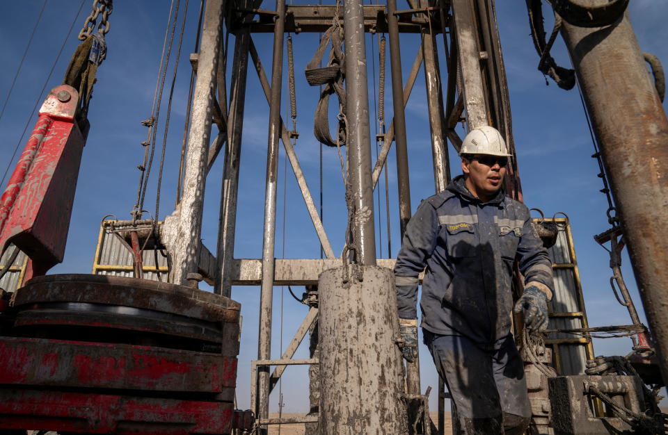 An oil and gas industry worker operates a drilling rig at Zhetybay field in the Mangystau region, Kazakhstan, November 13, 2023. REUTERS/Turar Kazangapov