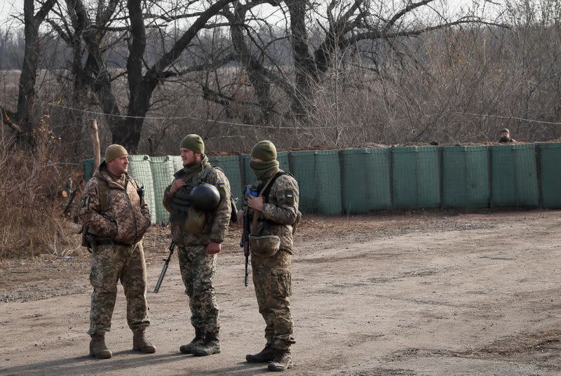 Servicemen are seen near the village of Zolote