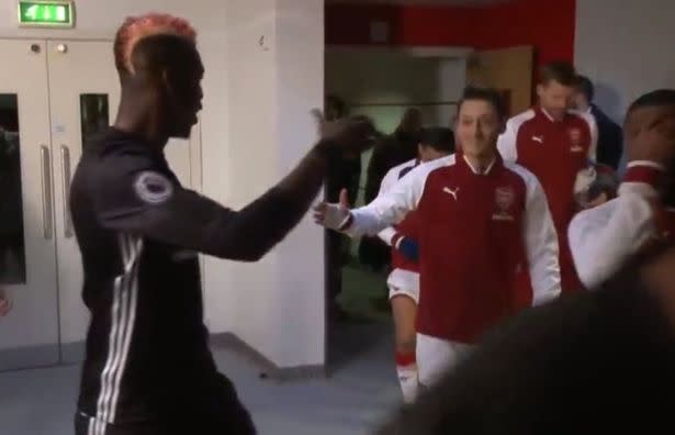 Paul Pogba locked onto Mesut Ozil