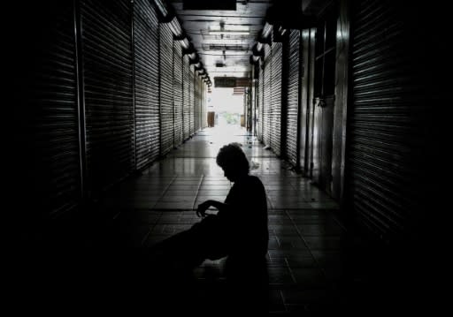 A homeless person sleeps outside shops in the "Roberto Huembes" market that are closed during a 24-hour nationwide general strike called by the opposition in Nicaragua