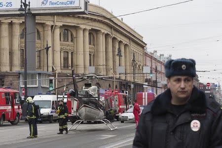 Members of the Emergency services stand next to a helicopter outside Tekhnologicheskiy institut metro station in St. Petersburg, Russia April 3, 2017. REUTERS/Ruslan Shamukov