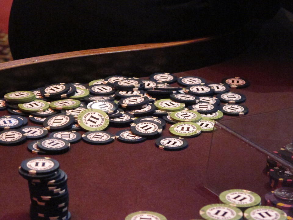 This Feb. 22, 2019 photo shows chips piled in a corner of a table at the Golden Nugget casino in Atlantic City, N.J. between games. New Jersey's casinos and horse tracks won $97.5 million in June, a decline of 65.6% from a year earlier during the final month of being closed due to the coronavirus outbreak. (AP Photo/Wayne Parry)