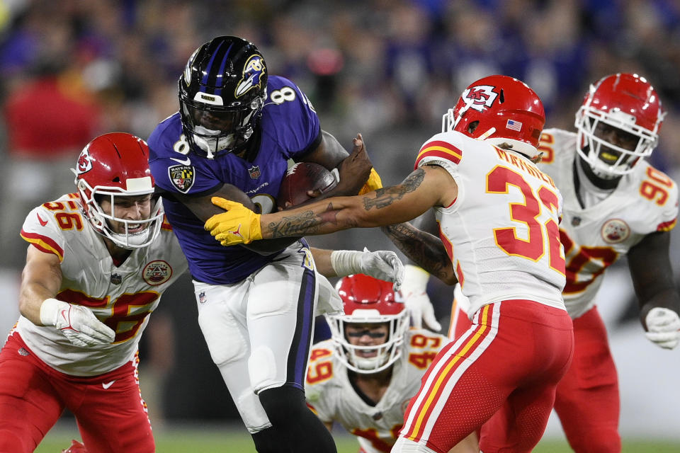 Baltimore Ravens quarterback Lamar Jackson (8) rushes against Kansas City Chiefs defenders in the first half of an NFL football game, Sunday, Sept. 19, 2021, in Baltimore. (AP Photo/Nick Wass)