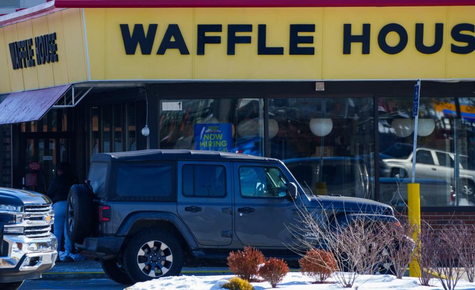 Vehicles block the entrance Monday, Feb. 19, 2024, to Waffle House, located at 2621 S Lynhurst Drive in Indianapolis, after a shooting overnight left one dead and five others injured.