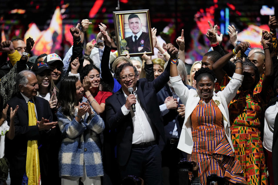 Former rebel Gustavo Petro and his running mate Francia Marquez, celebrate before supporters after winning a runoff presidential election in Bogota, Colombia, Sunday, June 19, 2022. (AP Photo/Fernando Vergara)