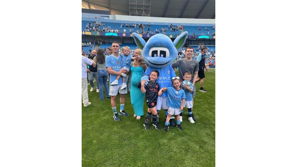 Phil Foden with his kids and partner Rebecca on the football pitch