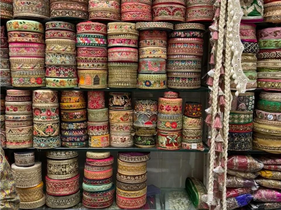 The shelves in a fabric store in India with intricate trimmings