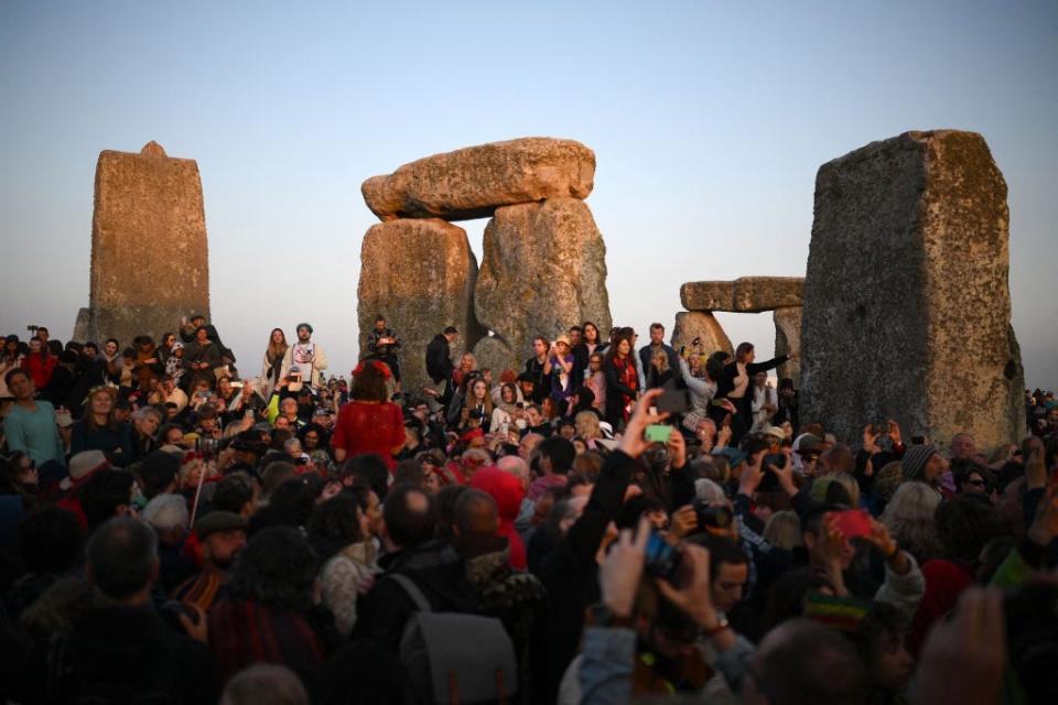 Revelers celebrate the Summer Solstice as the sun rises at Stonehenge on June 21, 2023, in a festival that dates back thousands of years.