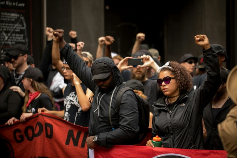 Members of Antifa get in formation after passing the security checkpoint required to enter the mall in downtown Charlottesville