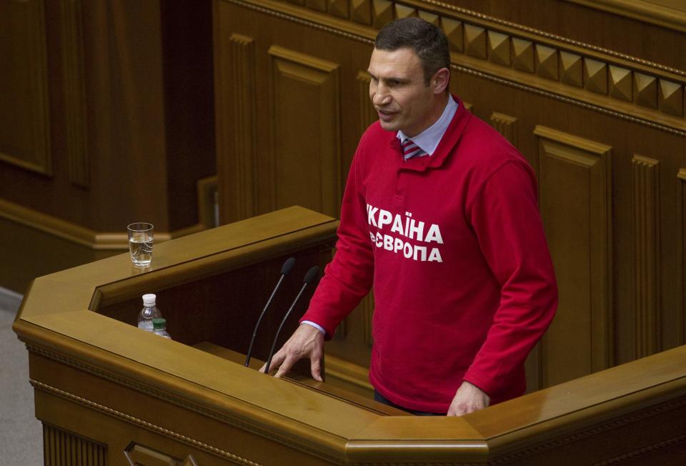 Ukrainian heavyweight boxer and opposition politician Vitaly Klitschko addresses parliament in Kiev, October 24, 2013. Klitschko said on Thursday he would run for president in a 2015 election. Klitshcko, 42, made his declaration angrily to parliament after the assembly, dominated by deputies from the ruling Party of Regions and its allies, passed a law amending tax legislation that could be used to prevent him from running for head of state. REUTERS/Valentyn Ogirenko (UKRAINE - Tags: POLITICS SPORT BOXING TPX IMAGES OF THE DAY)