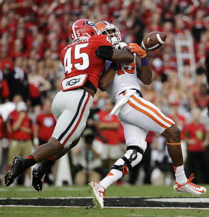 Georgia's Reggie Carter, left, breaks up a pass intended for Clemson's Charone Peake in the first half of an NCAA college football game, Saturday, Aug. 30, 2014, in Athens, Ga. (AP Photo/David Goldman)