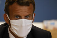 French President Emmanuel Macron meets staff and parents during a visit to a Mother and Child Protection Centre (PMI) in Longjumeau, a southern suburb of Paris, Wednesday, Sept. 23, 2020. French President wants to expand paternity leave to one month — and require fathers to take time off with their newborns. President Emmanuel Macron earlier announced the plan on Instagram before visiting the child-care facility. (Ludovic Marin/POOL via AP)