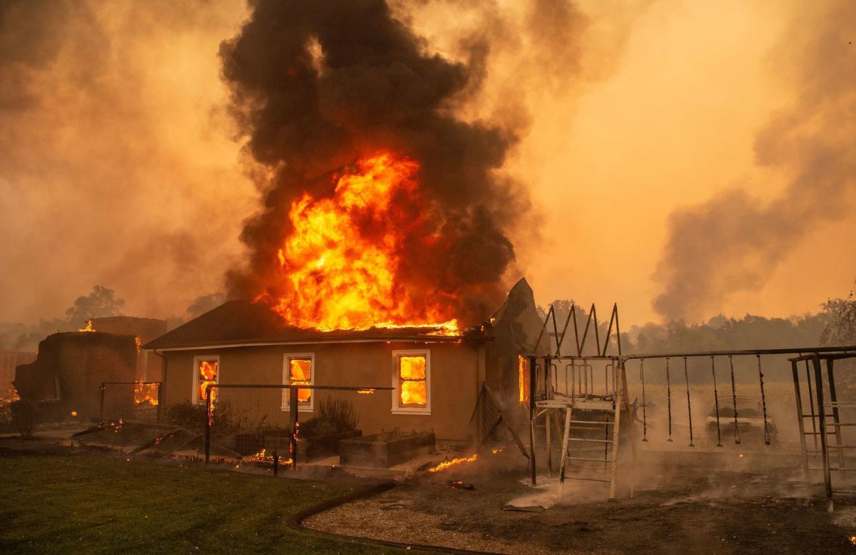 A home burns at a vineyard during the Kincade fire near Geyserville, Calif. on Oct. 24, 2019.