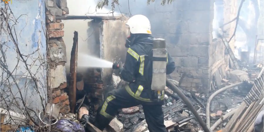 A rescuer tries to put out a fire that started as a result of shelling by Russian troops in the Mykolaiv region, Aug. 6