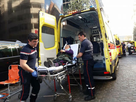 Medics help an injured woman after several people were injured and taken to hospital following clashes between supporters and opponents of the Turkish government outside the country's consulate in Brussels, in this handout picture released by Firat News Agency in Brussels, Belgium, March 30, 2017. Courtesy of Firat News Agency/Handout via REUTERS