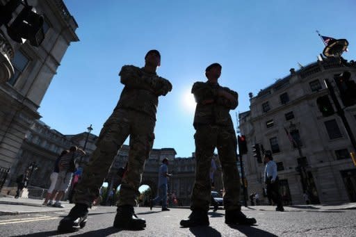 British soldiers guard the entrance to Horseguards, venue for the beach volleyball competition, in London on July 24. Britain has drafted in another 1,200 troops to plug a security gap at the London Olympics left by the failure of a private security firm to provide enough guards