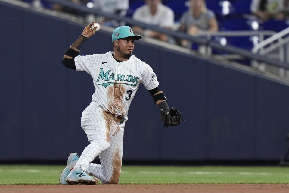 Miami Marlins second baseman Luis Arraez throws to first to put out Milwaukee Brewers' Carlos Santana during the first inning of a baseball game, Friday, Sept. 22, 2023, in Miami. (AP Photo/Wilfredo Lee)