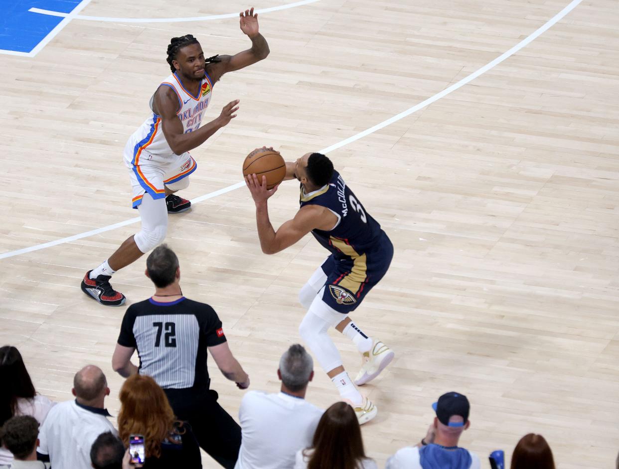 Thunder guard Cason Wallace (22) defends Pelicans guard CJ McCollum (3) on the last possession of Game 1 Sunday night.