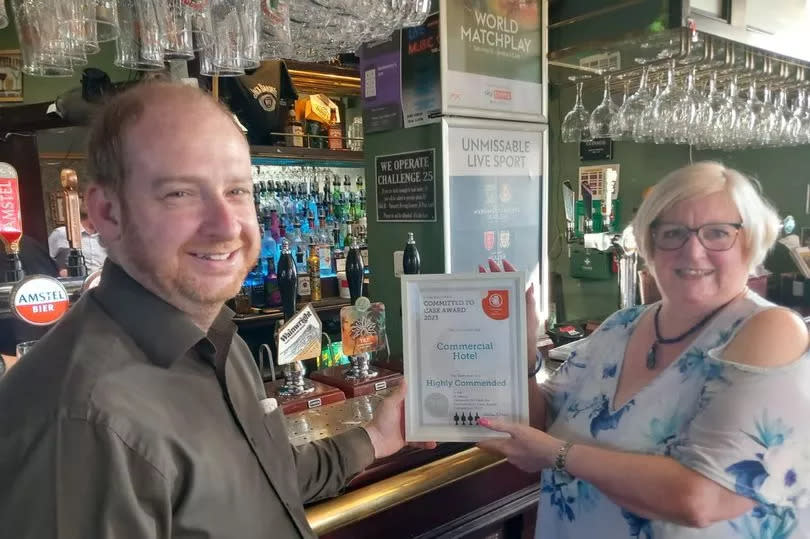 Operator Mark Woodward recieves his CAMRA award at The Commercial Hotel in Rainhill