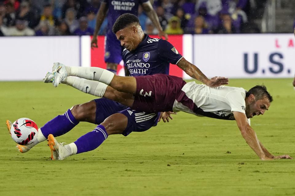 Orlando City's Junior Urso, left, and Sacramento Republics's Dami Viader fall while going for the ball during the first half of the U.S. Open Cup final soccer match Wednesday, Sept. 7, 2022, in Orlando, Fla. (AP Photo/John Raoux)