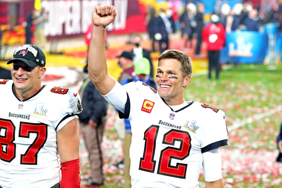 Tampa Bay Buccaneers quarterback Tom Brady (12) and tight end Rob Gronkowski (87) celebrate after beating the Kansas City Chiefs in Super Bowl LV at Raymond James Stadium.