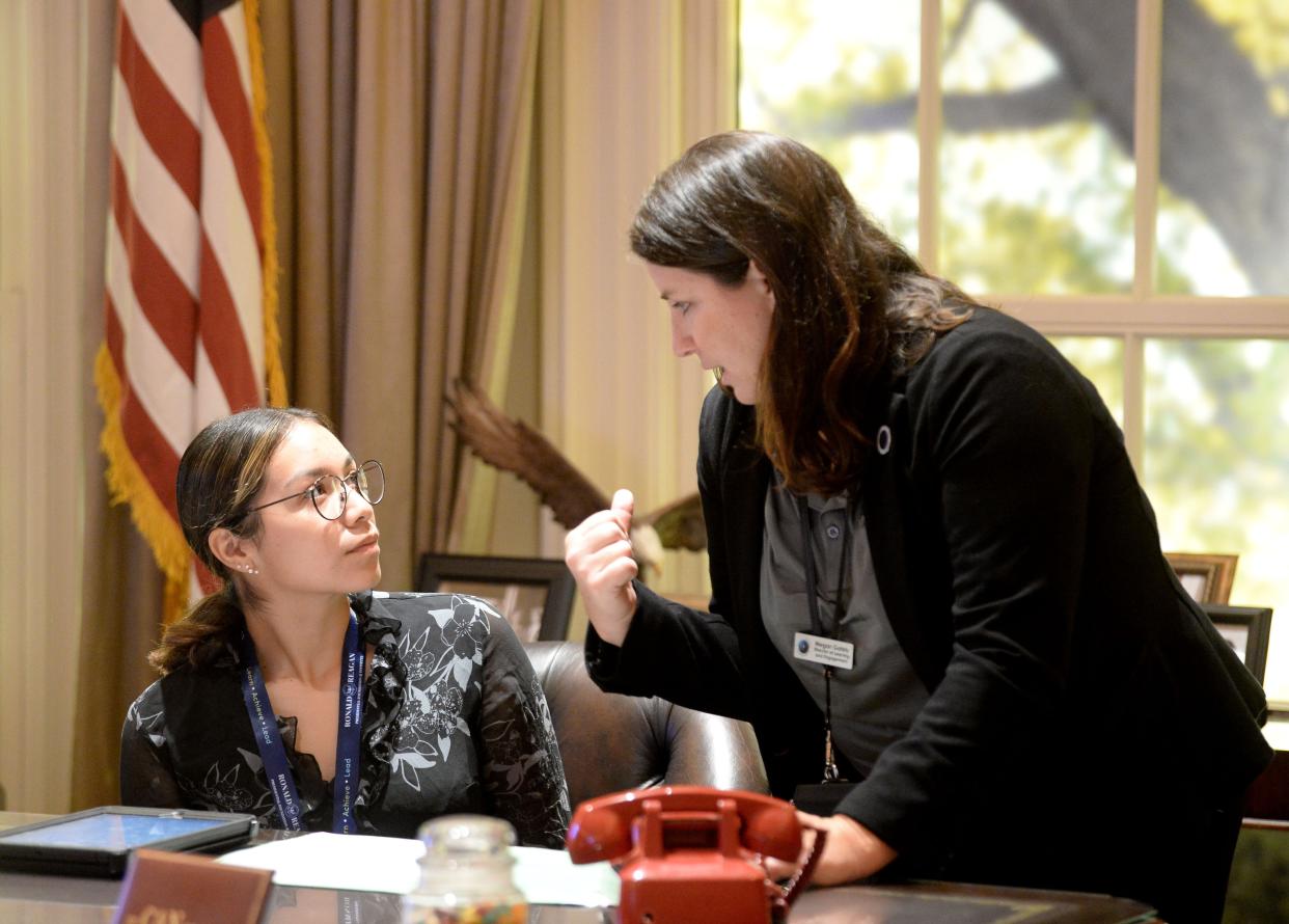 Royal High School senior Gabi Muñoz, left, discusses strategy with program designer Megan Gately Tuesday inside a mock-up of the Oval Office at the Ronald Reagan Presidential Library & Museum in Simi Valley. Muñoz was playing the role of U.S. president.