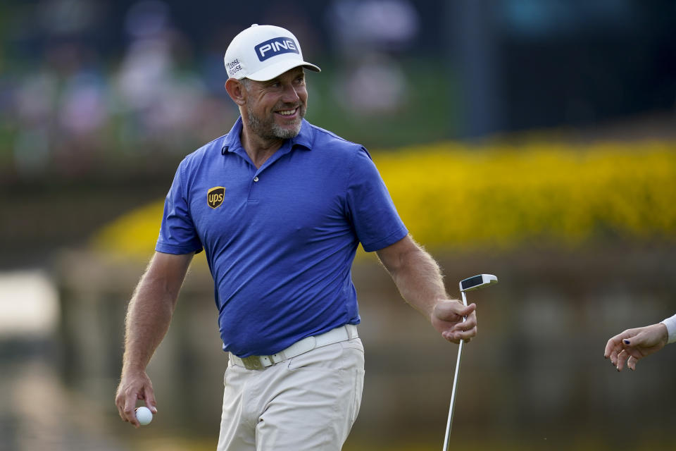 Lee Westwood, of England, smiles after making a birdie putt on the 16th hole during the third round of The Players Championship golf tournament Saturday, March 13, 2021, in Ponte Vedra Beach, Fla. (AP Photo/Gerald Herbert)