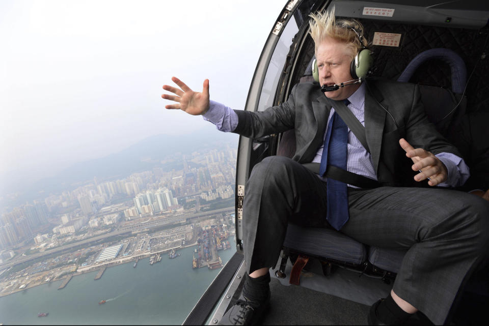 FILE - In this Thursday Oct. 17, 2013 file photo Mayor of London Boris Johnson looks at the skyline during helicopter ride over Hong Kong. (AP Photo/Andrew Parsons/Pool, File)