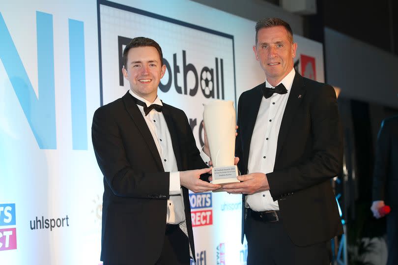 A picture of Crusaders boss Stephen Baxter receiving his Hall of Fame award from Michael Clarke