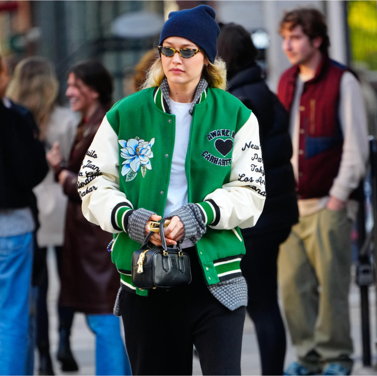  Gigi Hadid in a green varsity jacket. 