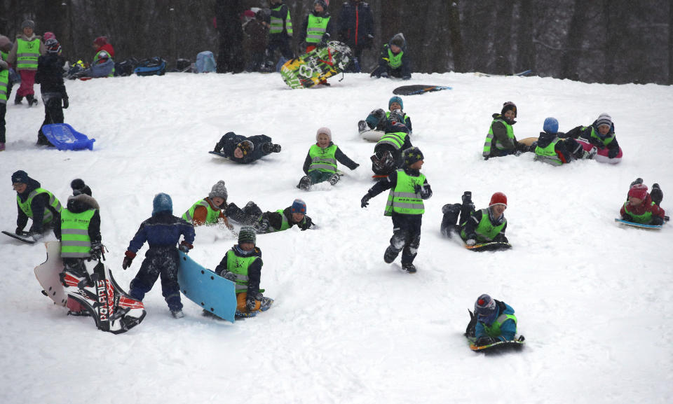 Children enjoy the snow covered slopes after overnight cold weather brought snow to the region, in Oslo, Norway, Wednesday Jan. 16, 2019. (Erik Johansen / NTB scanpix via AP)