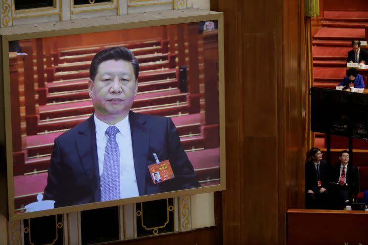 A screen shows Chinese President Xi Jinping during the second plenary session of the National People's Congress.