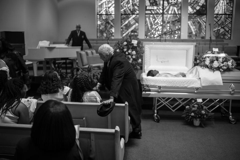 <p>Spencer Leak Sr consoles a family at a funeral he helped organize at the New Life Center Church COGIC on Chicago’s South Side. (Photo: Jon Lowenstein/NOOR for Yahoo News) </p>